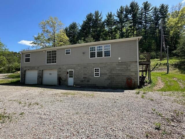 35310 Geiger Rd, Logan, OH 43138 - rear view of house featuring a garage and driveway