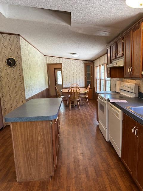 35310 Geiger Rd, Logan, OH 43138 - kitchen featuring a textured ceiling, wallpapered walls, white appliances, dark countertops, and under cabinet range hood