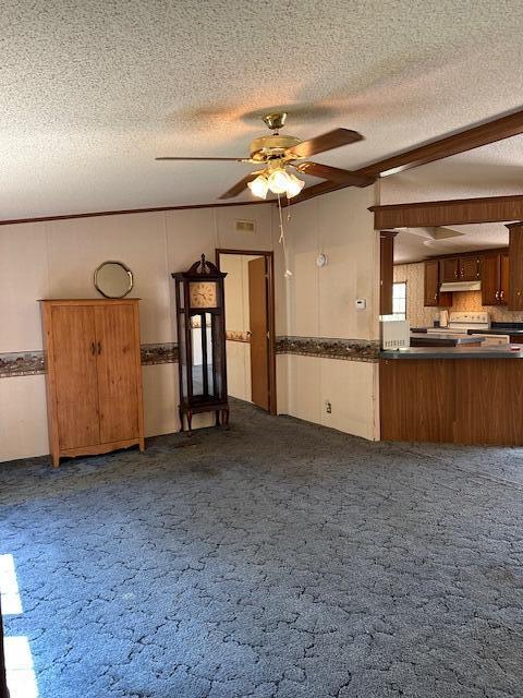 35310 Geiger Rd, Logan, OH 43138 - unfurnished living room featuring a textured ceiling, a ceiling fan, and dark carpet