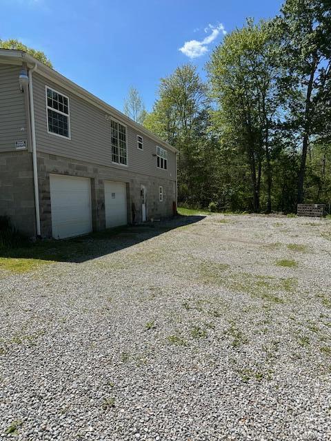 35310 Geiger Rd, Logan, OH 43138 - rear view of house with an attached garage and driveway