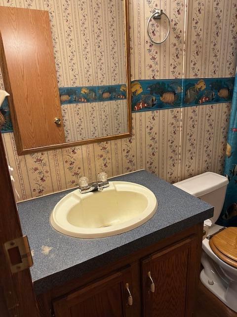35310 Geiger Rd, Logan, OH 43138 - bathroom with vanity, toilet, and wallpapered walls