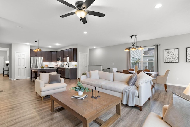 6464 Rockhold Dr, Westerville, OH 43081 - living room with light wood-type flooring, baseboards, recessed lighting, and ceiling fan