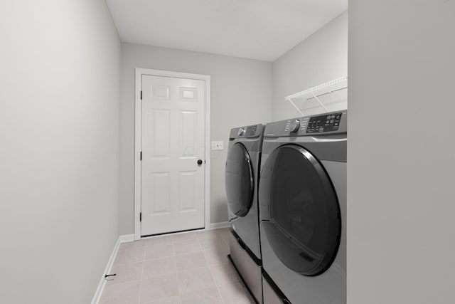 6464 Rockhold Dr, Westerville, OH 43081 - laundry area with washing machine and clothes dryer, baseboards, and light tile patterned flooring