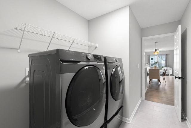 6464 Rockhold Dr, Westerville, OH 43081 - laundry room featuring washing machine and clothes dryer, light tile patterned floors, baseboards, and ceiling fan