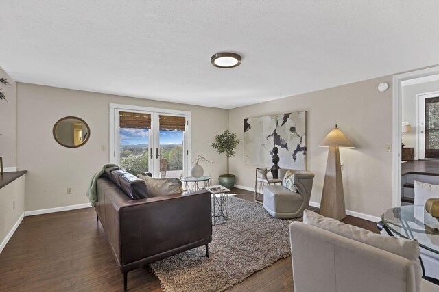 living room with a healthy amount of sunlight, baseboards, and dark wood-style floors