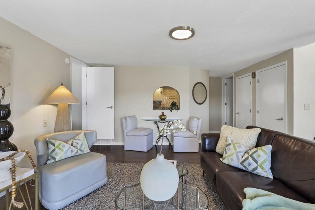 living area with baseboards and wood finished floors