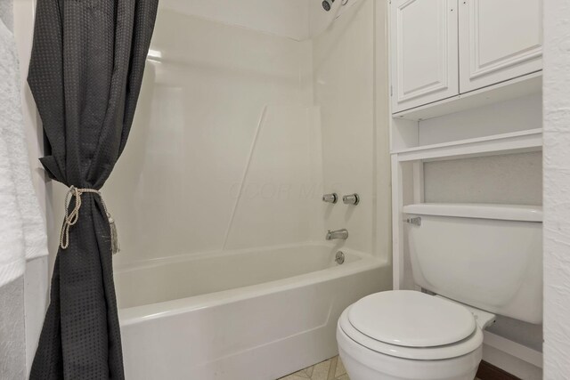full bathroom with toilet and shower / bath combination with curtain