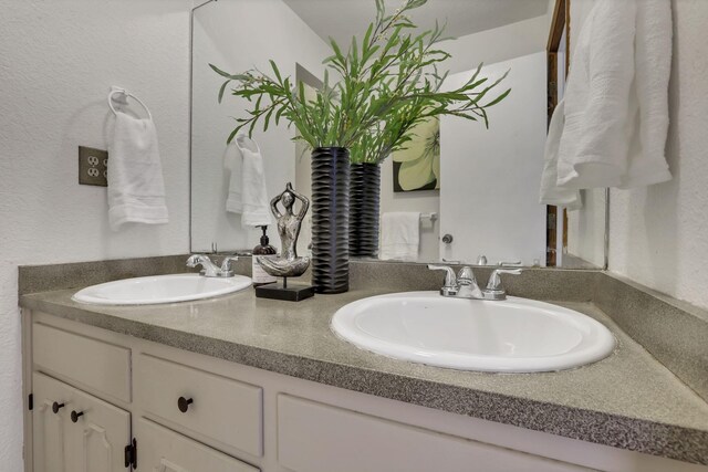 bathroom featuring double vanity and a sink