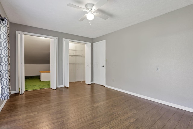 unfurnished bedroom with baseboards, ceiling fan, and dark wood finished floors