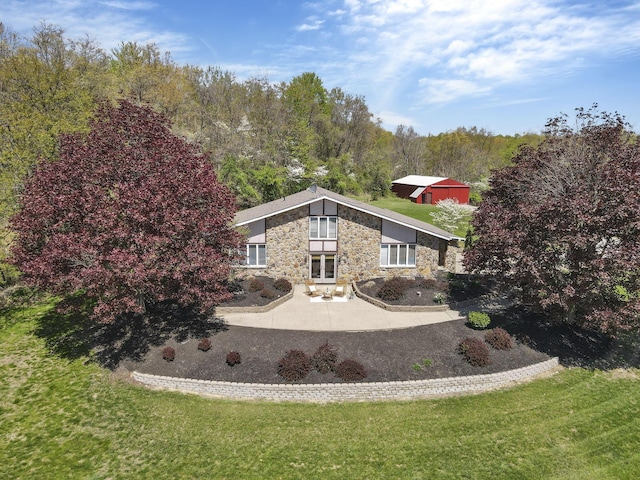 view of front of home featuring a front lawn and stone siding