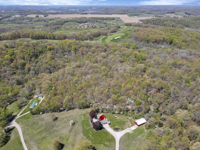 birds eye view of property featuring a wooded view