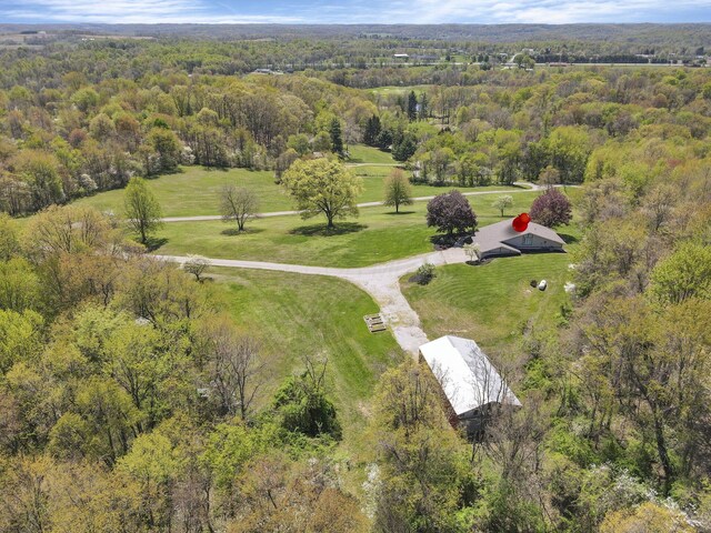 birds eye view of property featuring a wooded view