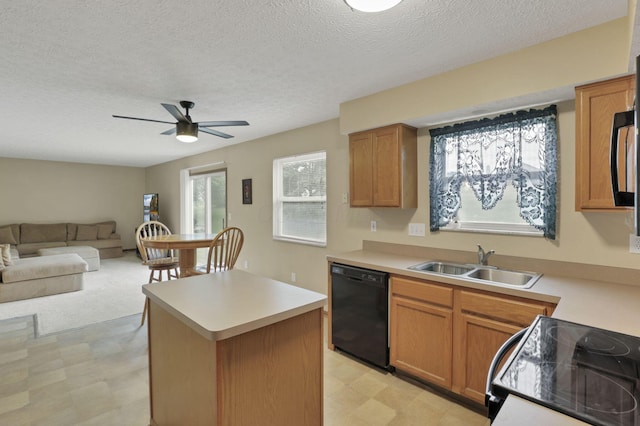 6495 Saylor St, Canal Winchester, OH 43110 - kitchen with black appliances, light floors, a sink, open floor plan, and light countertops
