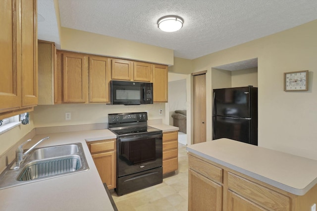 6495 Saylor St, Canal Winchester, OH 43110 - kitchen featuring black appliances, a sink, light countertops, a textured ceiling, and light flooring