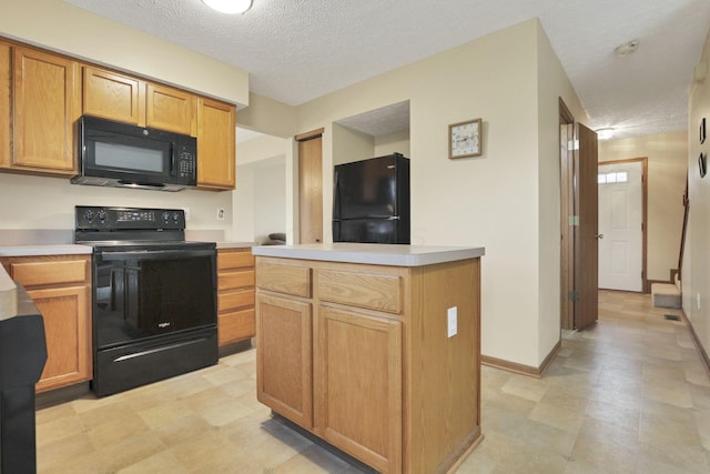 6495 Saylor St, Canal Winchester, OH 43110 - kitchen featuring black appliances, a textured ceiling, light countertops, light floors, and baseboards