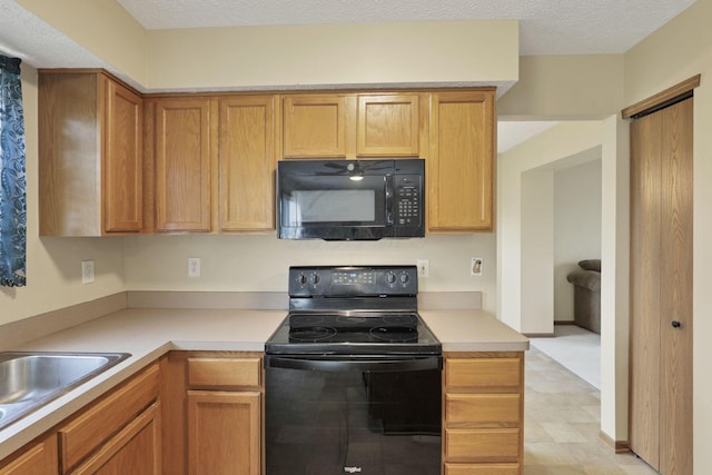 6495 Saylor St, Canal Winchester, OH 43110 - kitchen with black appliances, light countertops, and a sink