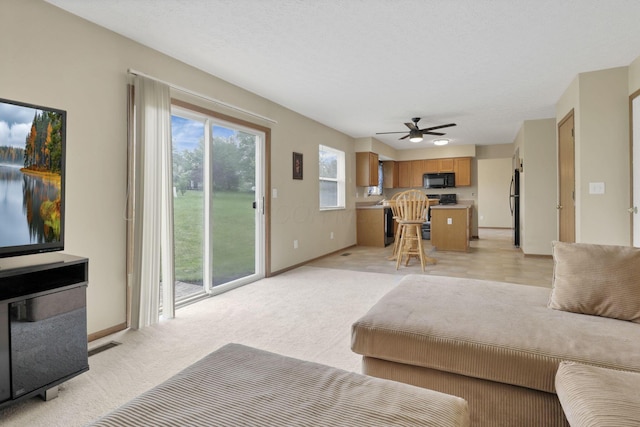 6495 Saylor St, Canal Winchester, OH 43110 - living room featuring a ceiling fan, baseboards, and light colored carpet