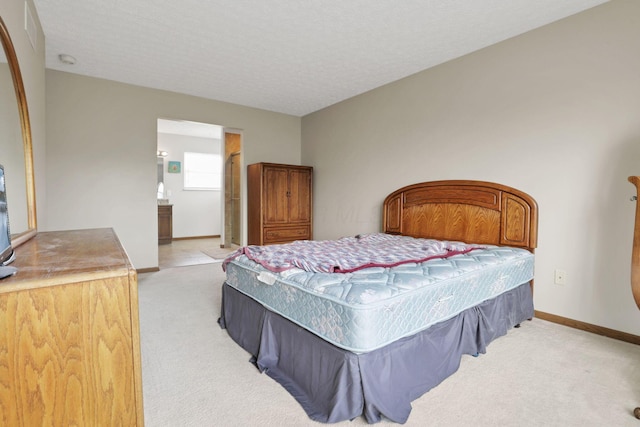 6495 Saylor St, Canal Winchester, OH 43110 - bedroom with light carpet, baseboards, ensuite bath, and a textured ceiling