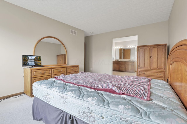 6495 Saylor St, Canal Winchester, OH 43110 - bedroom with light carpet, a textured ceiling, connected bathroom, and baseboards