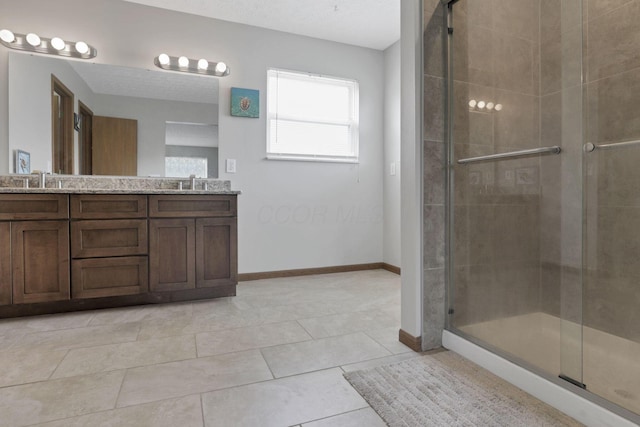 6495 Saylor St, Canal Winchester, OH 43110 - full bath with double vanity, a stall shower, baseboards, and tile patterned floors