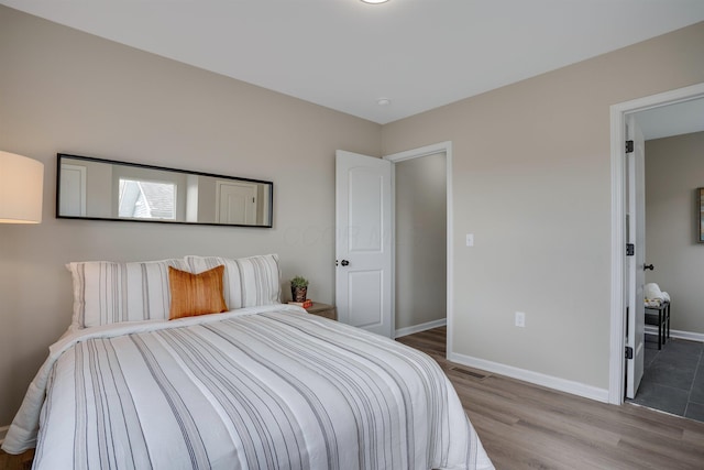 295 W Park Ave, Columbus, OH 43223 - bedroom featuring baseboards, wood finished floors, and visible vents