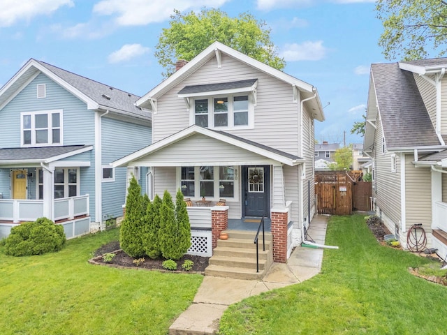 view of front of home featuring covered porch and a gate