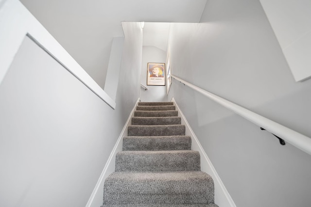 staircase featuring baseboards