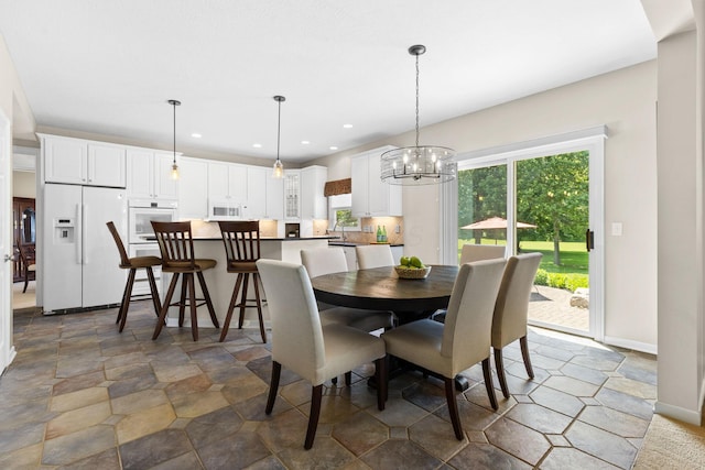 2543 Kemperwood Dr, Blacklick, OH 43004 - dining area with a chandelier, recessed lighting, stone finish floors, and baseboards