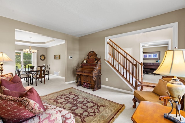 2543 Kemperwood Dr, Blacklick, OH 43004 - living area with a chandelier, carpet floors, baseboards, stairway, and a tray ceiling