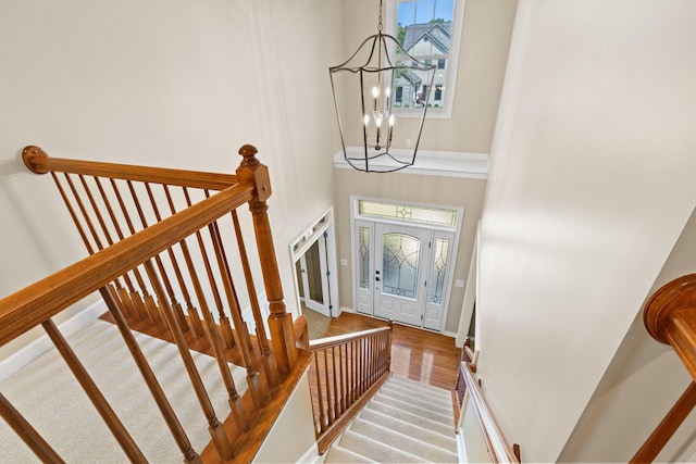 2543 Kemperwood Dr, Blacklick, OH 43004 - foyer with a chandelier, a towering ceiling, baseboards, stairs, and wood finished floors