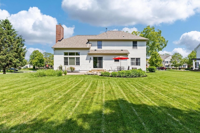 2543 Kemperwood Dr, Blacklick, OH 43004 - back of property featuring a lawn, a patio, and a chimney