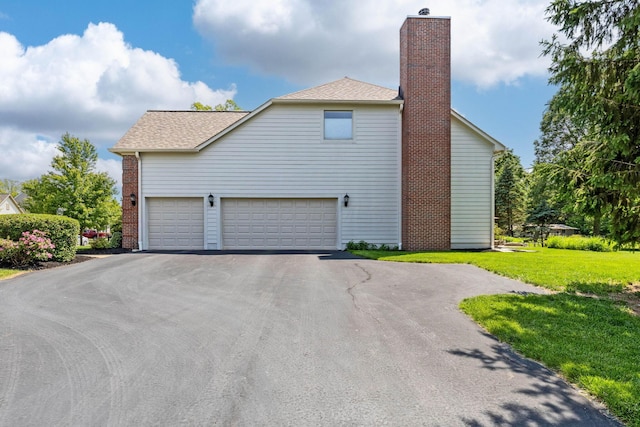 2543 Kemperwood Dr, Blacklick, OH 43004 - view of property exterior featuring driveway, a chimney, a yard, and roof with shingles