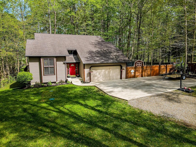 view of front of house featuring driveway, fence, a front lawn, an attached garage, and a shingled roof