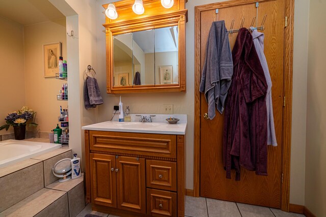 full bathroom featuring vanity, tile patterned floors, and a garden tub