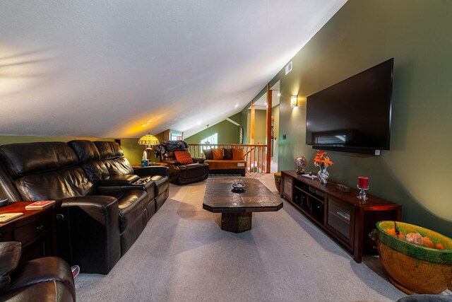 living area featuring carpet floors, vaulted ceiling, and visible vents
