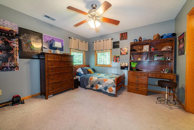 bedroom featuring baseboards, ceiling fan, carpet, and visible vents
