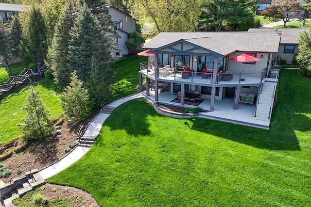rear view of house featuring a yard, a patio, a deck, and stairs