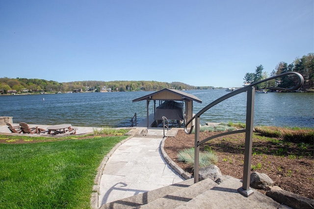 dock area with a water view and boat lift
