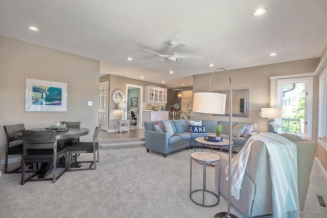 living area featuring a ceiling fan, baseboards, recessed lighting, and carpet