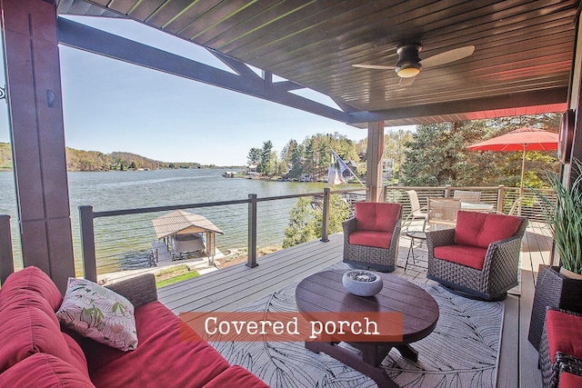 wooden terrace featuring a water view and ceiling fan