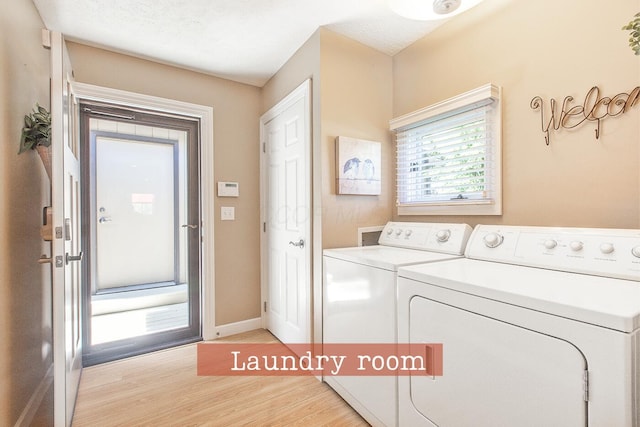 clothes washing area with laundry area, baseboards, light wood-type flooring, and independent washer and dryer