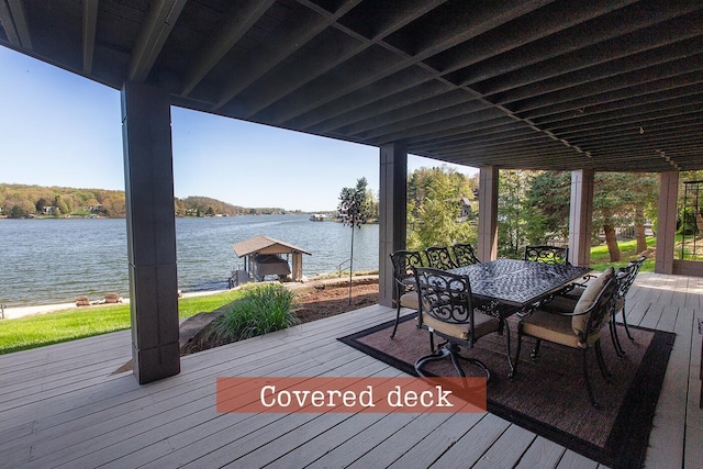 wooden terrace featuring a water view