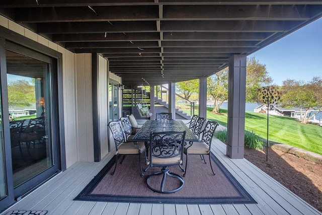 wooden terrace featuring stairs and outdoor dining area