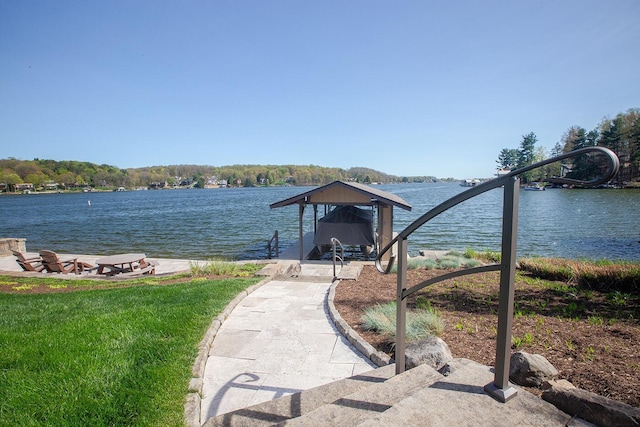 dock area with boat lift and a water view