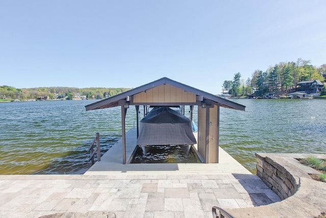 dock area with a water view and boat lift