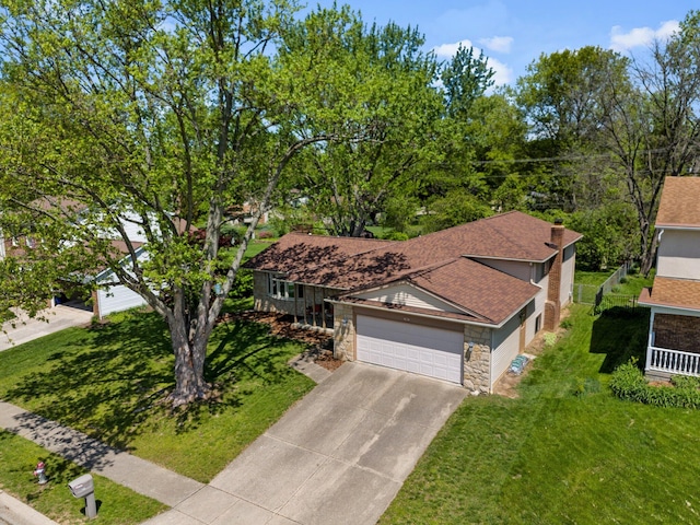 746 Ronson Ave, Columbus, OH 43230 - view of front facade featuring stone siding, driveway, a garage, and a front lawn