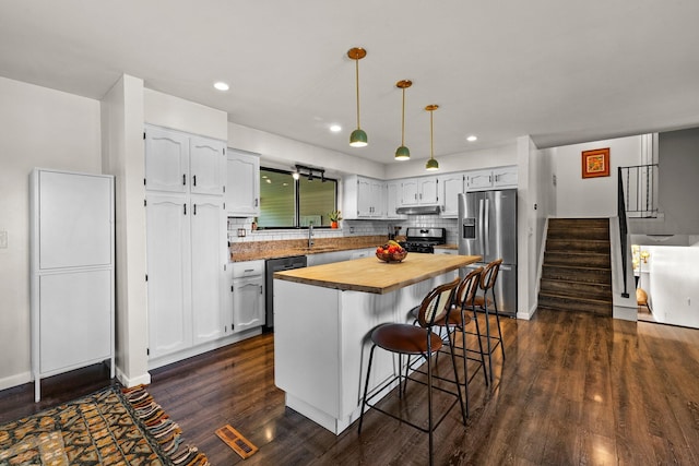746 Ronson Ave, Columbus, OH 43230 - kitchen featuring stainless steel appliances, wood counters, white cabinetry, dark wood-type flooring, and recessed lighting