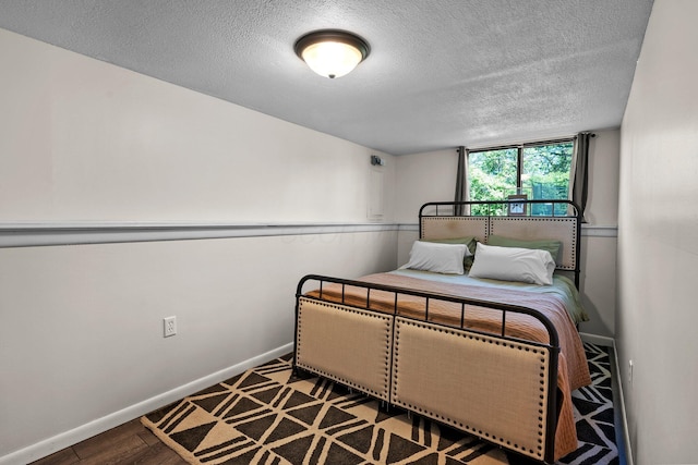 746 Ronson Ave, Columbus, OH 43230 - bedroom with a textured ceiling, baseboards, and wood finished floors