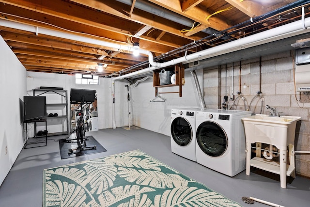 746 Ronson Ave, Columbus, OH 43230 - washroom with washing machine and clothes dryer and concrete block wall