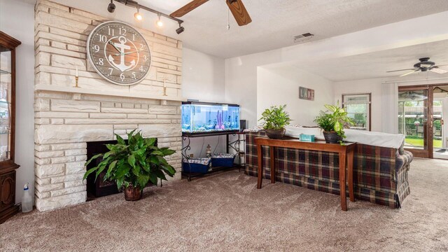 14672 Township Rd Unit 1062, Thornville, OH 43076 - living area with a ceiling fan, carpet flooring, and a stone fireplace